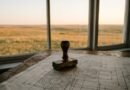 Approval stamp on a technical blueprint beside a prairie window, representing NRC advanced reactor licensing